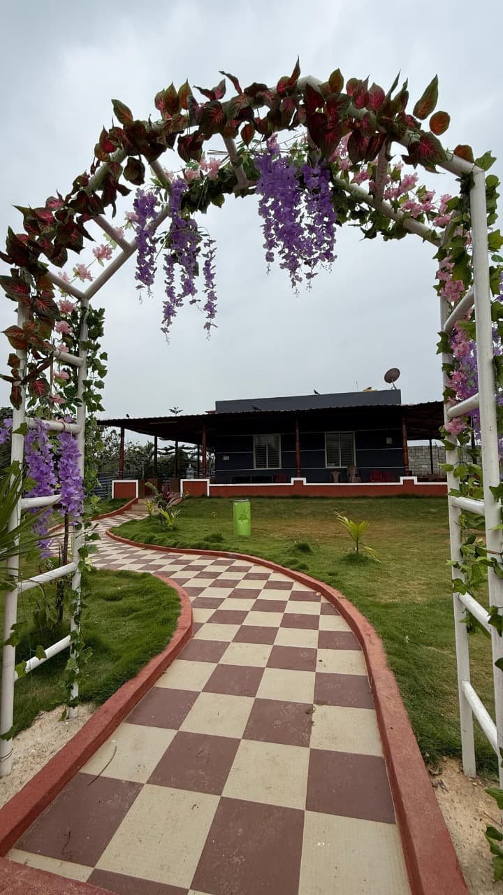 Flower-covered arch and pathway leading to the villa