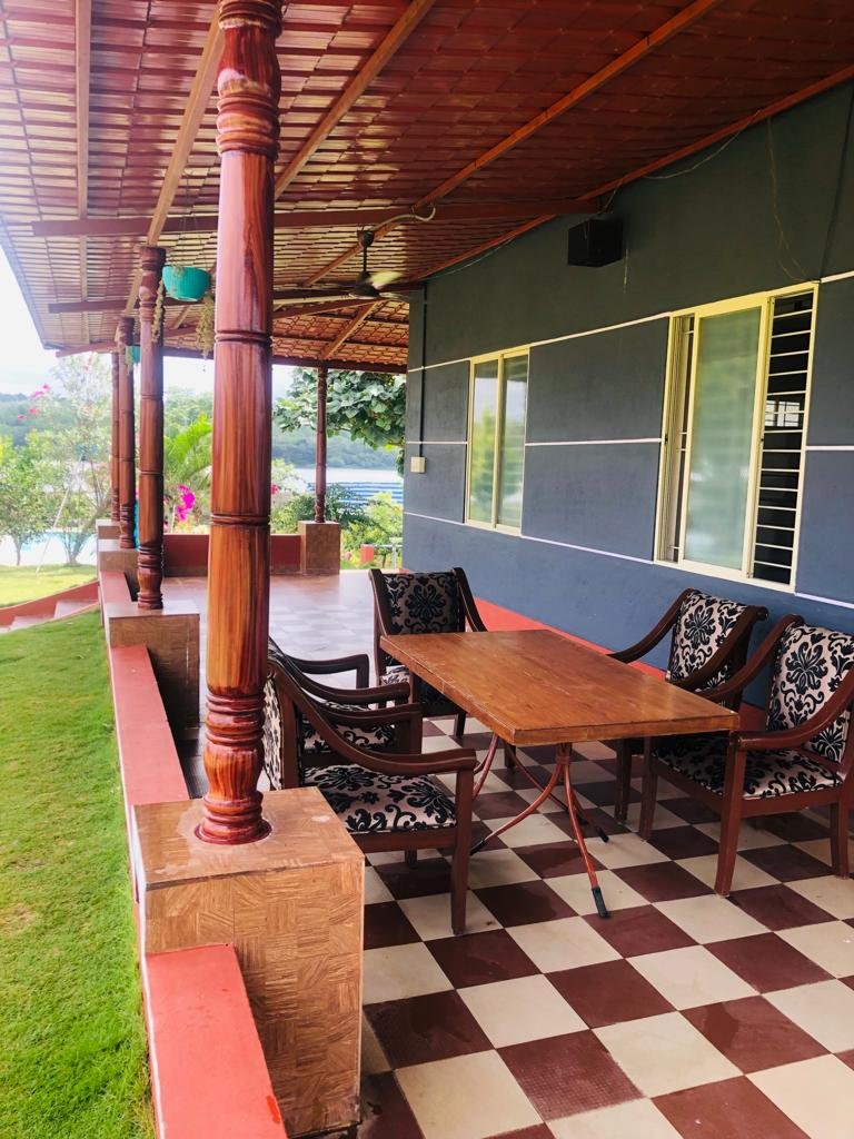 Covered villa veranda with table and chairs